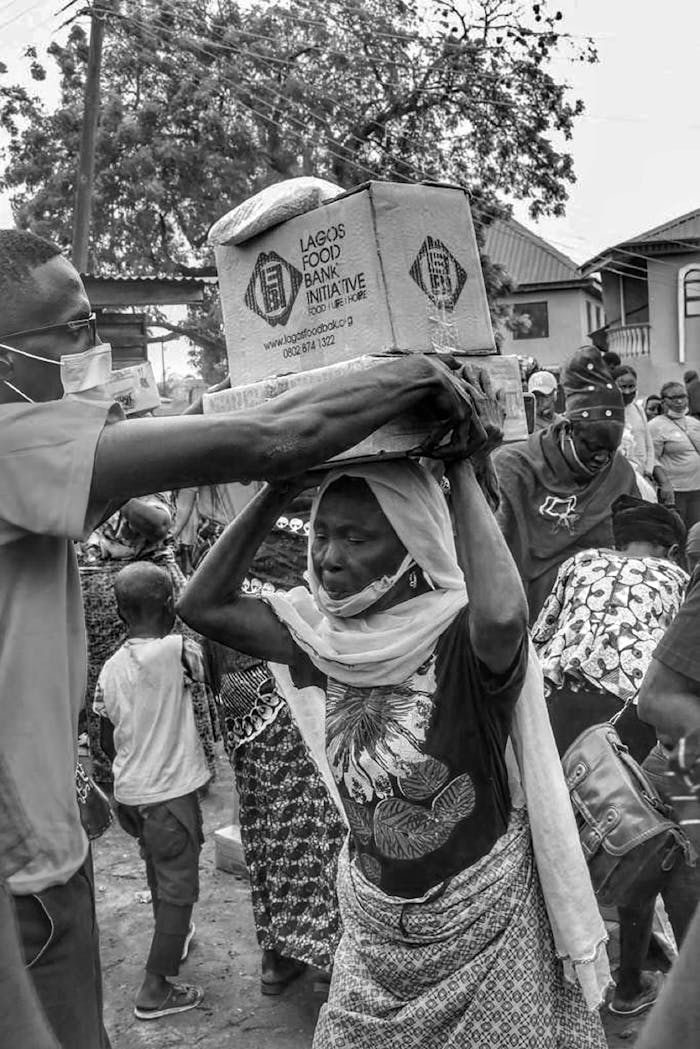 Volunteers help distribute food boxes during a charity event in Lagos.